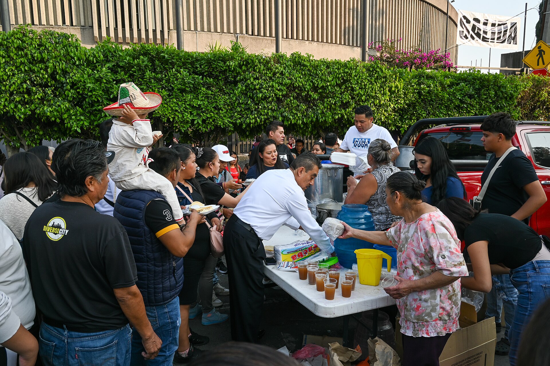 Volunteers handing out food and drinks from a table on the street to pilgrims arriving at the Basílica de Guadalupe in Mexico City on 12 December