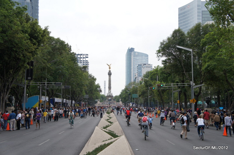 Paseo de la Reforma closed to traffic and filled with cyclists and pedestrians, with the Angel of Independence monument in the distance