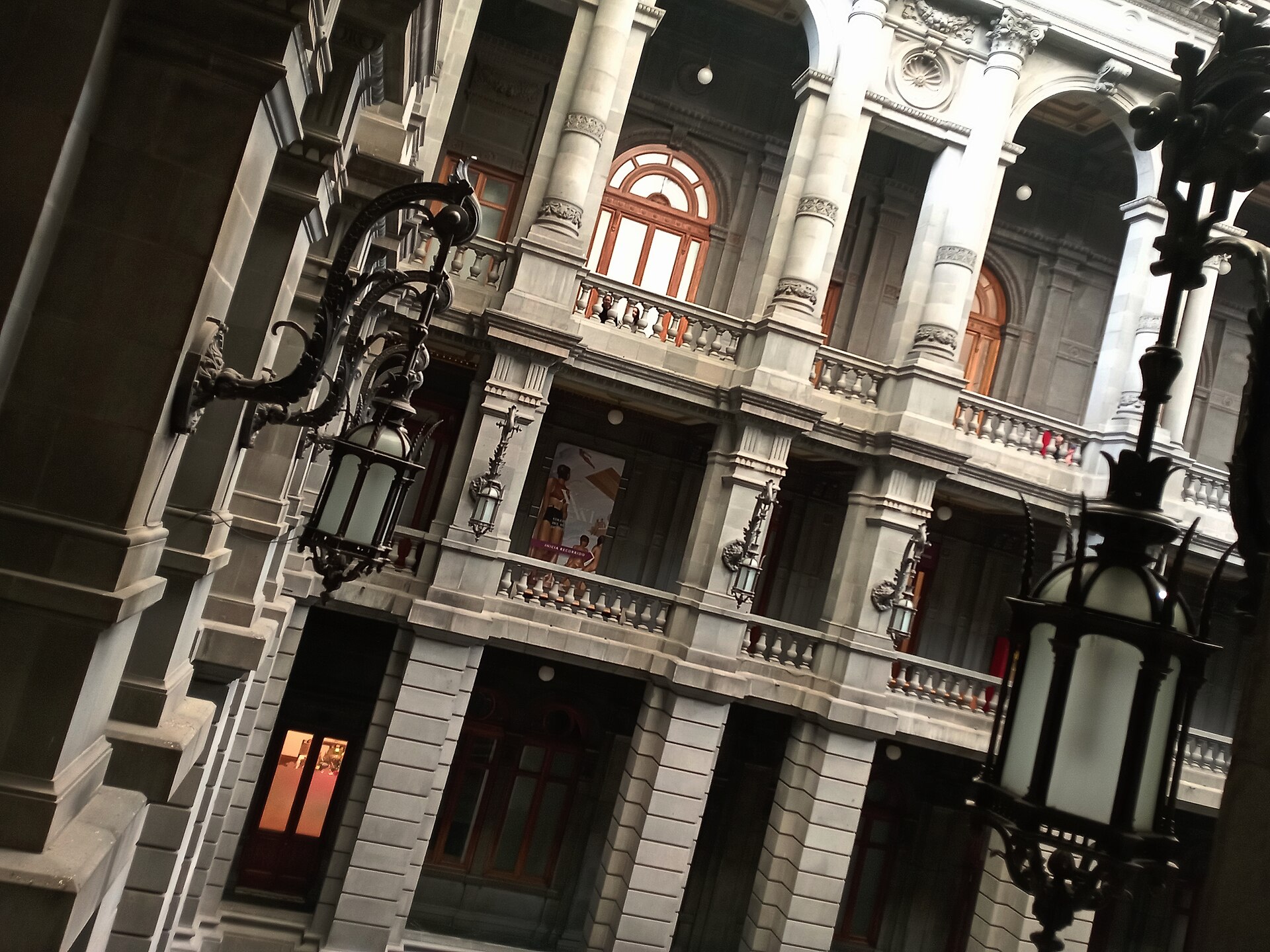 The ornate stone courtyard facade and wrought-iron lamps of the Museo Nacional de Arte in Mexico City
