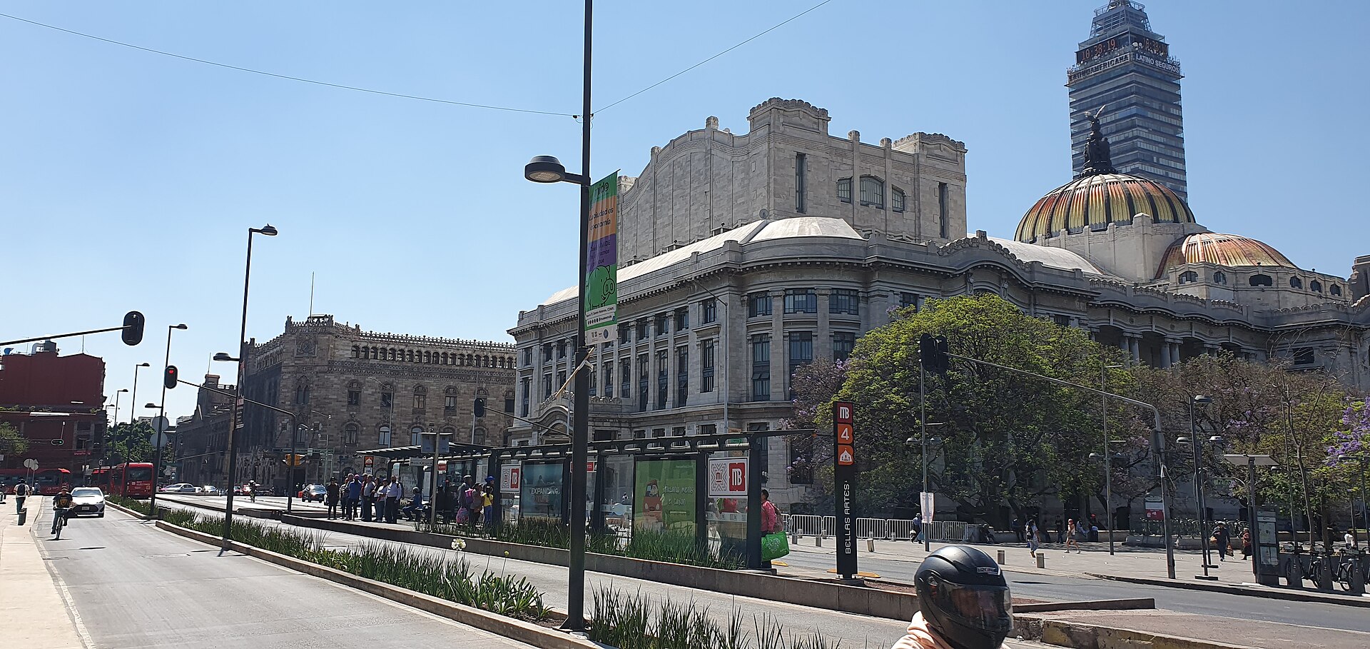 The Palacio de Bellas Artes with its cream marble facade and orange dome seen from the street, with the Torre Latinoamericana behind