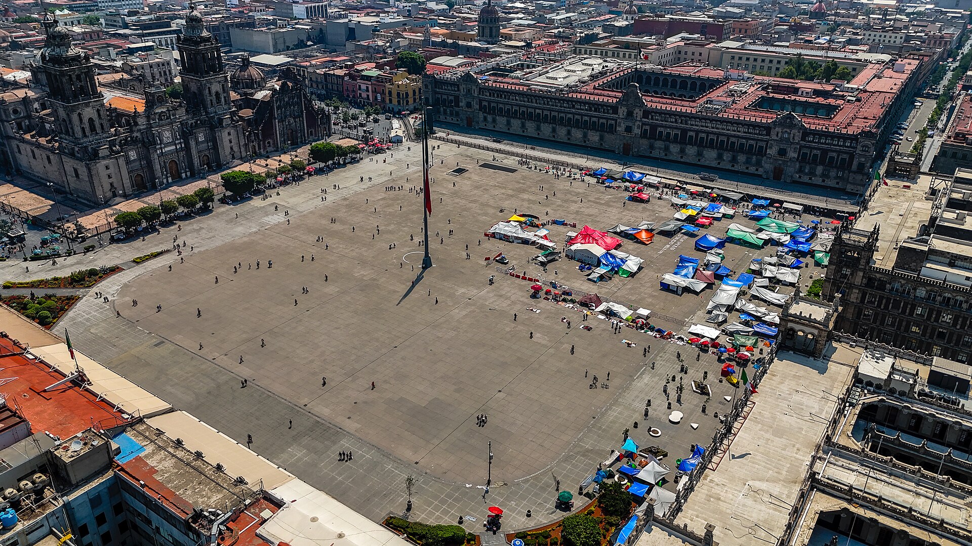Aerial view of the Zocalo in Mexico City with the Metropolitan Cathedral on one side and the Palacio Nacional along another side of the square